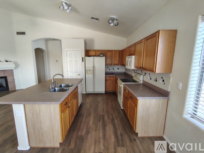 A kitchen with wooden cabinets and a white refrigerator.