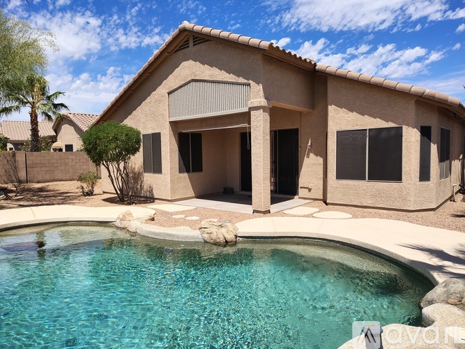 A house with a pool in front of it.