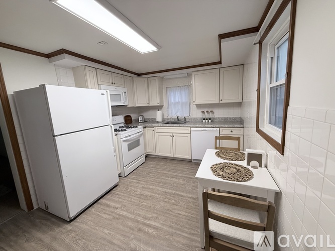 A kitchen with white appliances and a white refrigerator.