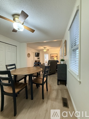 A dining room with a table and chairs.