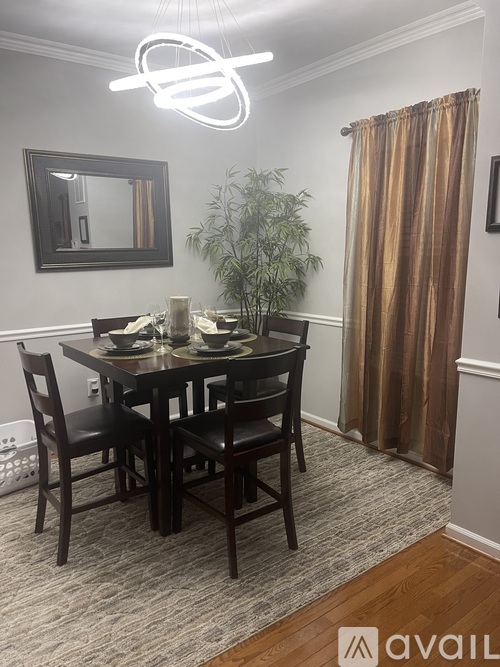 A dining room with a table set for four.