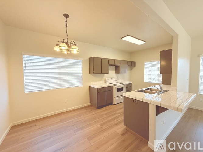 A kitchen with a wooden floor and a large island.