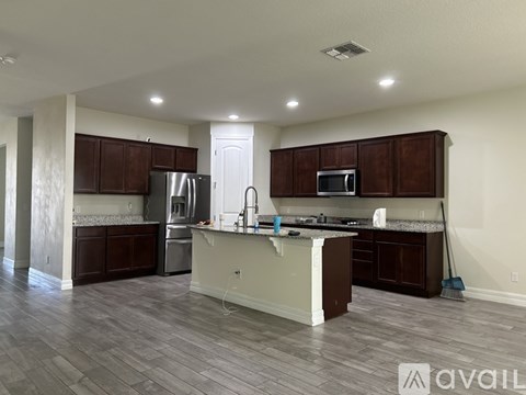 A kitchen with brown cabinets and a white island.