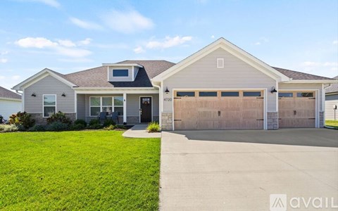 A two-story house with a garage is available for sale.