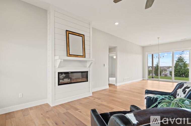 A living room with a fireplace and a painting on the wall.