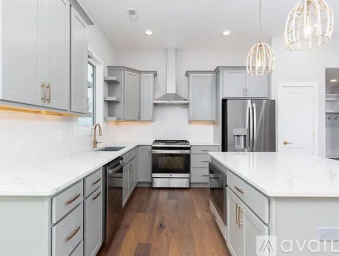 A modern kitchen with white cabinets and a central island.
