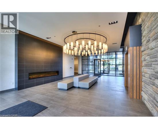 A modern interior space with a stone wall and a fireplace.