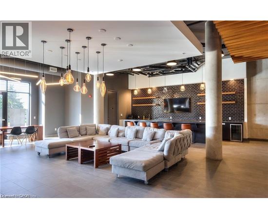 A modern living room with a large sectional sofa and a wooden coffee table.