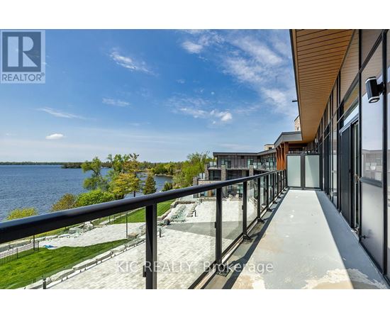 A balcony overlooks a body of water with a building in the background.