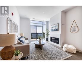 A living room with a fireplace and a large window.