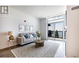 A living room with a grey couch, a coffee table, and a rug.