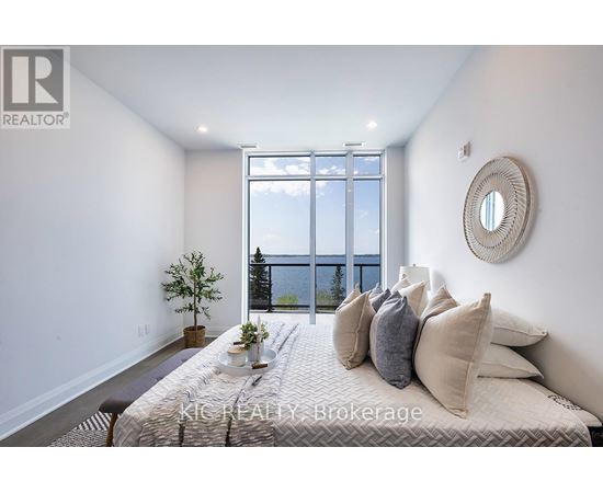 A bedroom with a large bed and a view of the city.