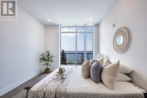 A bedroom with a large bed and a view of the city.