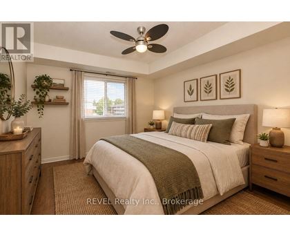 A bedroom with a large bed, a ceiling fan, and a window with curtains.