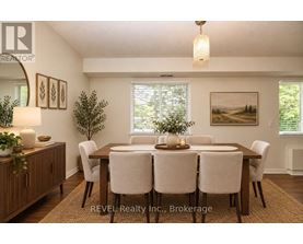 A dining room with a wooden table and chairs.