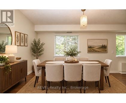 A dining room with a wooden table and chairs.