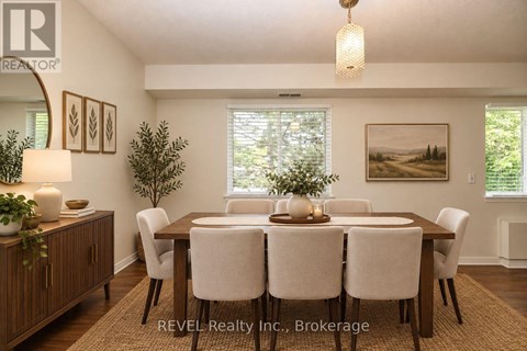 A dining room with a wooden table and chairs.