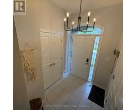 A hallway with a light fixture and a door.
