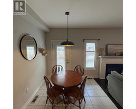 A dining room with a wooden table and chairs.