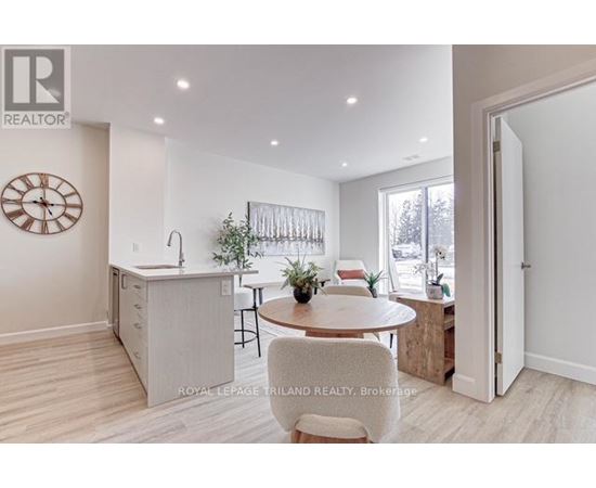 A well-lit kitchen with a dining table and chairs.