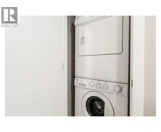 A white washing machine with the door open.