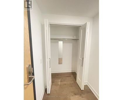 A white door is open to a hallway.