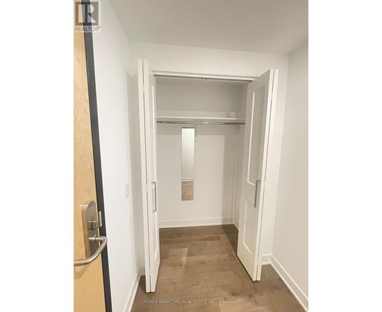 A white door is open to a hallway.