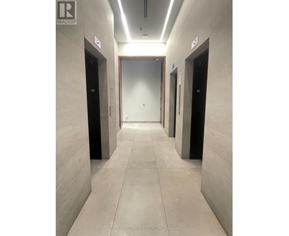 A hallway with elevator doors numbered 10, 2, and 6.