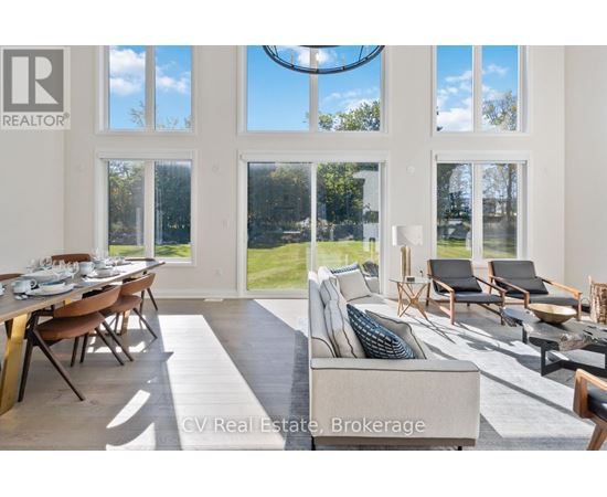 A well-lit living room with a dining table and chairs.