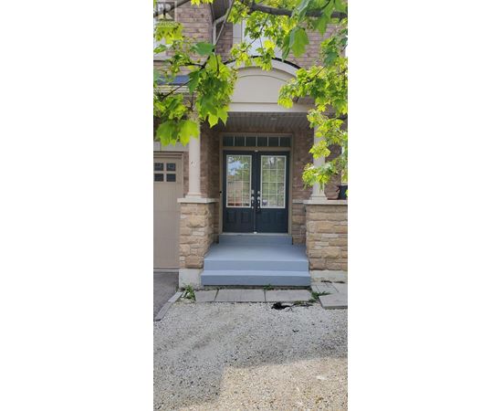 A house with a black front door and a white garage door.