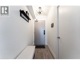A hallway with a door and a bench.