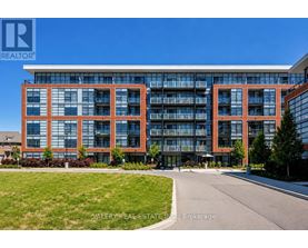 A modern multi-story building with glass windows and balconies.