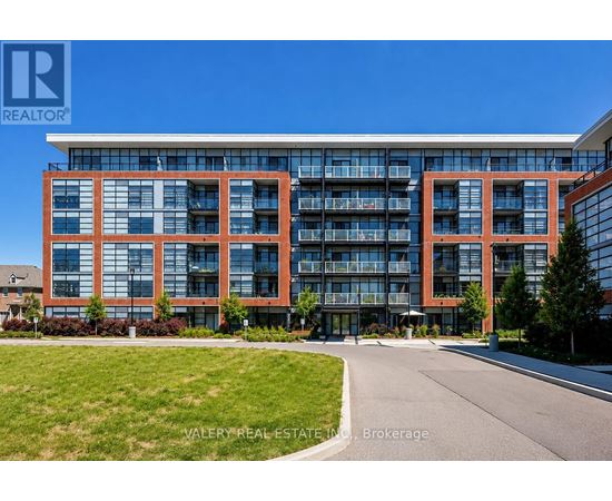 A modern multi-story building with glass windows and balconies.