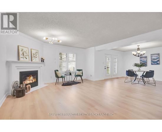 A living room with a fireplace and a dining table set up.