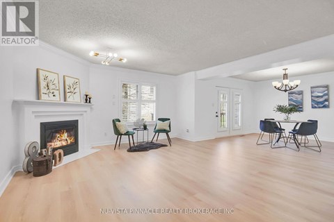 A living room with a fireplace and a dining table set up.