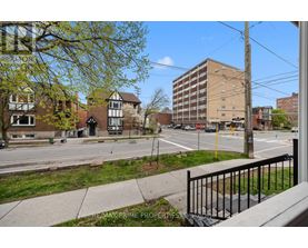 A street view with a building in the background and a sign that says REMAX PRIME PROPERTIES.