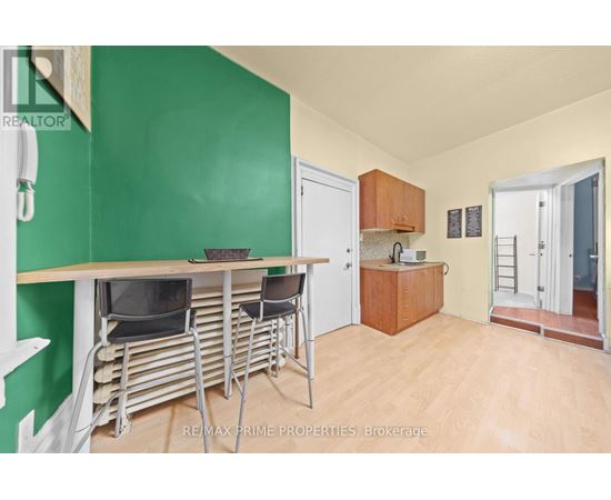 A dining area with a table and chairs in a room with green walls.