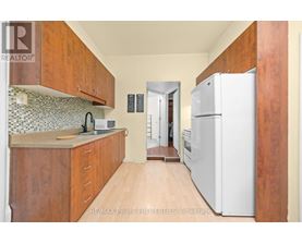 A kitchen with wooden cabinets and a white refrigerator.