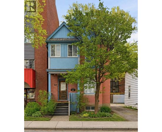 A blue house with a tree in front of it.