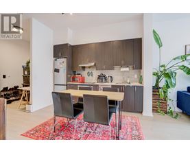 A modern kitchen with a dining table and chairs.