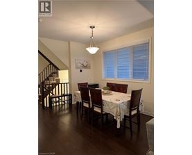 A dining room with a table set for four.