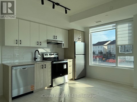 A modern kitchen with wooden cabinets and stainless steel appliances.