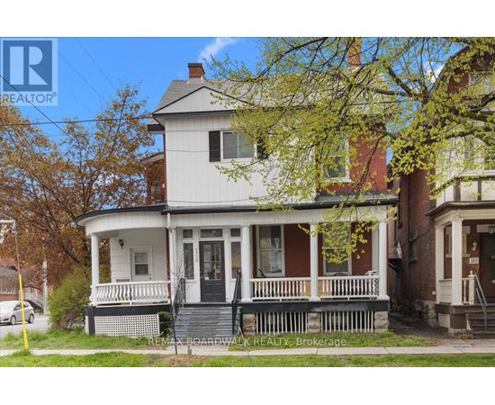 A house with a white front porch and a black door.
