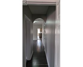 A long hallway with a door at the end.