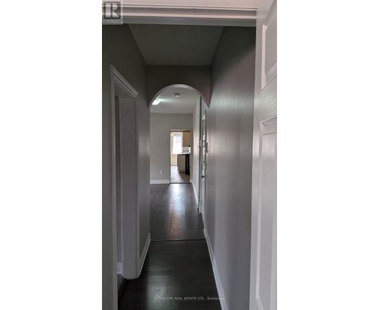 A long hallway with a door at the end.