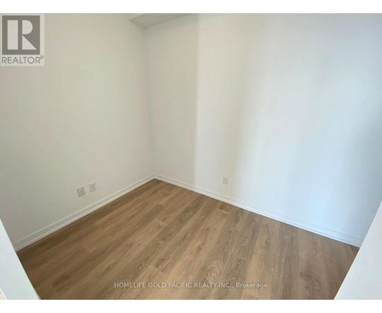 A room with wooden flooring and white walls.