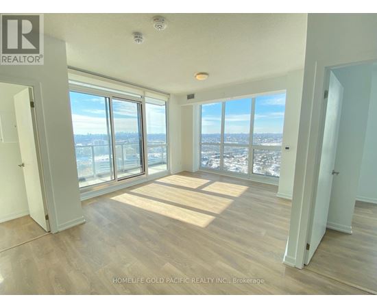 A room with a view of the city through large windows.