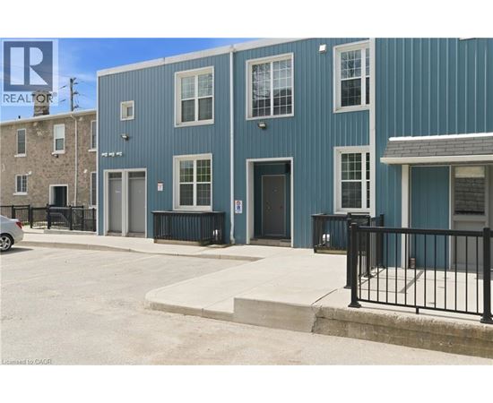 A blue building with a black fence in front.