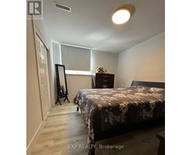 A bedroom with a bed, dresser, and mirror.