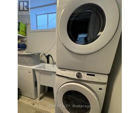 A washing machine is stacked on top of another one.